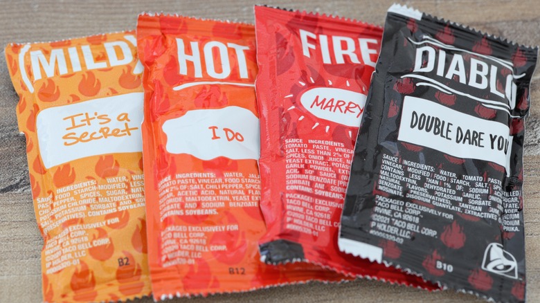 taco bell red sauces in packets on table