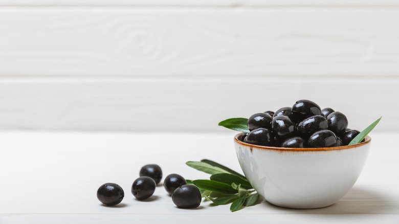 bowl of black olives on table