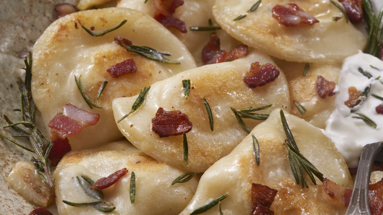 Perfectly cooked pierogi with bacon and herbs