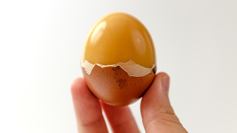 Partially peeled smoked egg
