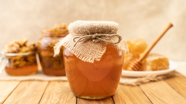 honey in jar on wood table