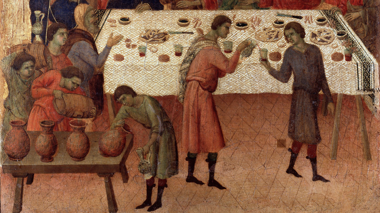 Close-up on a medieval Italian mural depicting a banquet