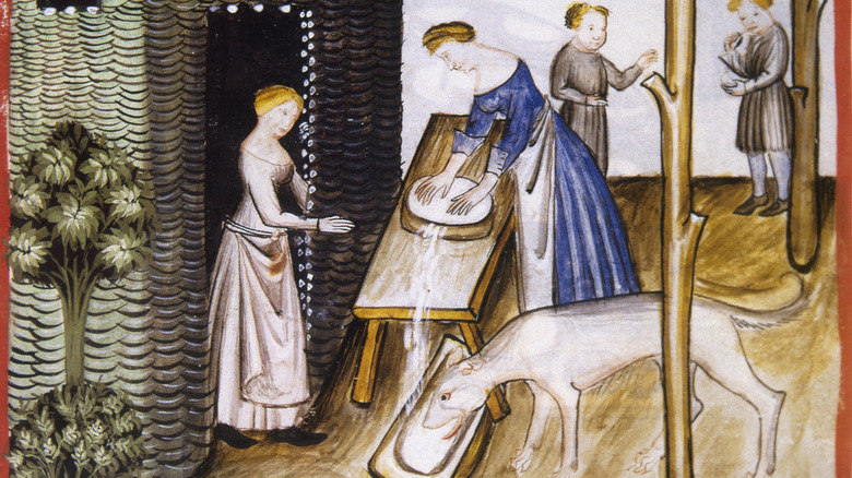Medieval illustration of women making cheese