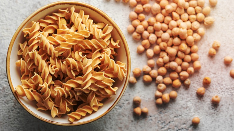 Chickpea fusilli pasta surrounded by garbanzo beans