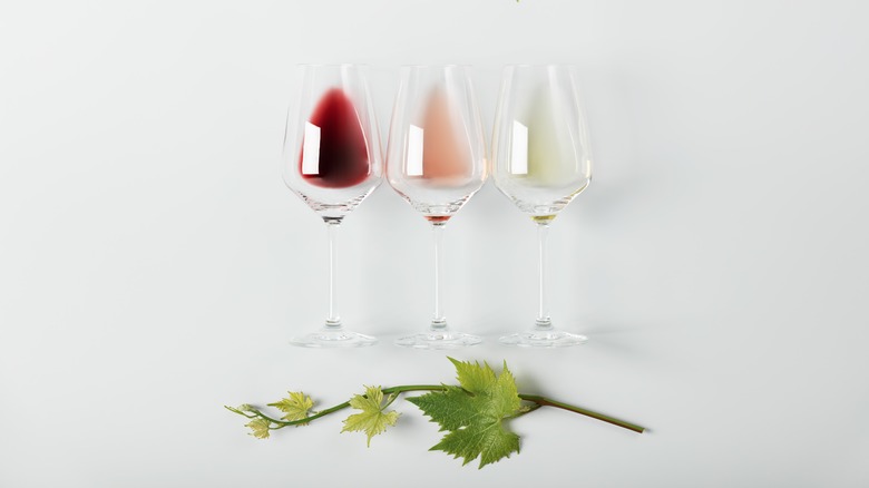 glasses laying on side with three types of wine