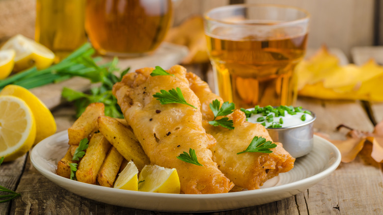 beer battered fish and chips with beer and garnish