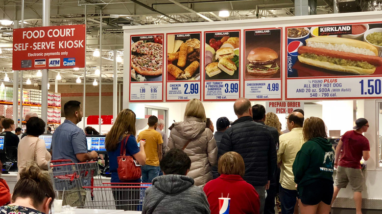 People waiting for Kirkland brand food at Costco, $1.50 hot dog
