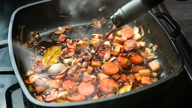 wine deglazing pan of vegetables