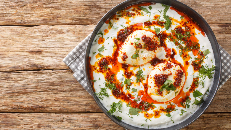 A plate of Turkish eggs on a wooden table
