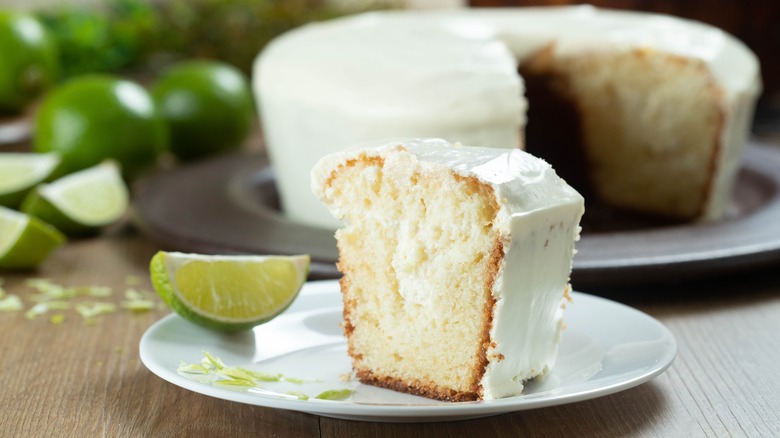 Slice of gin and tonic cake on a plate with bundt cake in the background