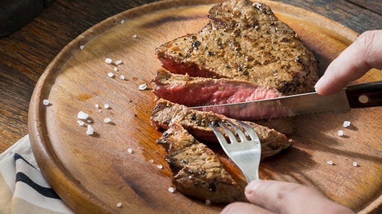Person cutting into steak