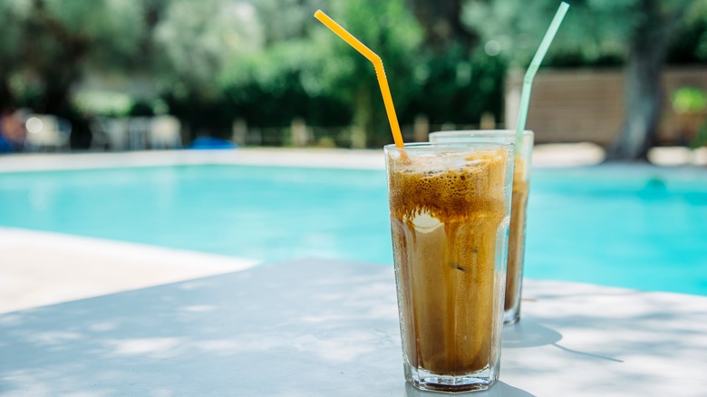Two frappe drinks by a pool 