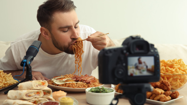 man eating in front of camera