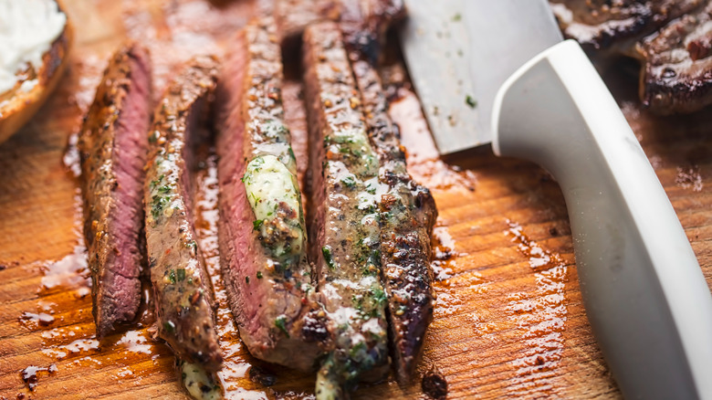 cut up steak with herb butter 