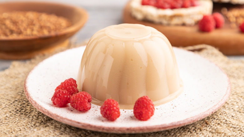 milk jelly dome with raspberries on a plate