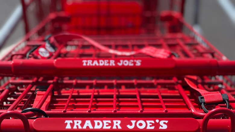 A stack of red trader joe's shopping carts