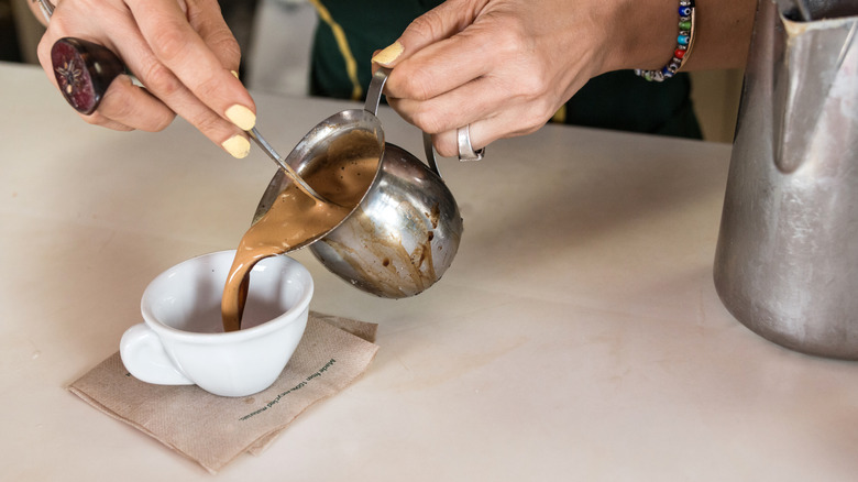 Person pouring Cuban coffee