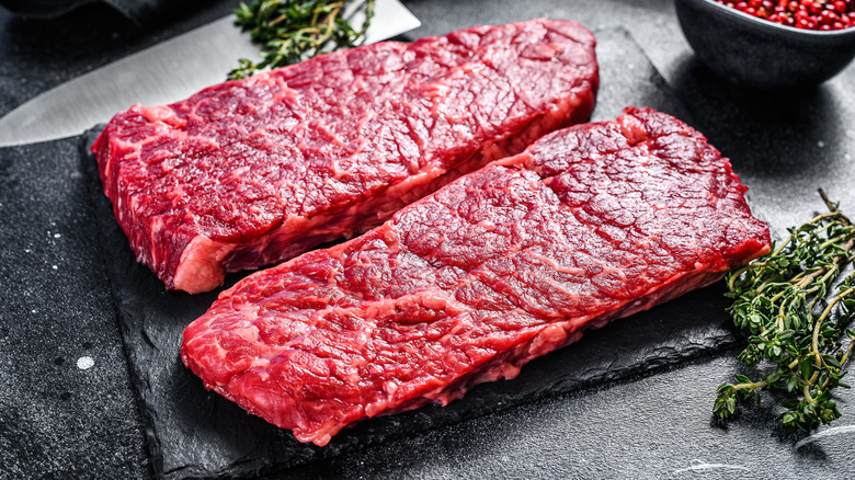 two raw Denver steaks