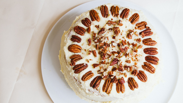 Frosted white cake with pecans