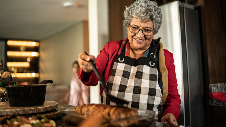 Woman pouring sauce on backstrap