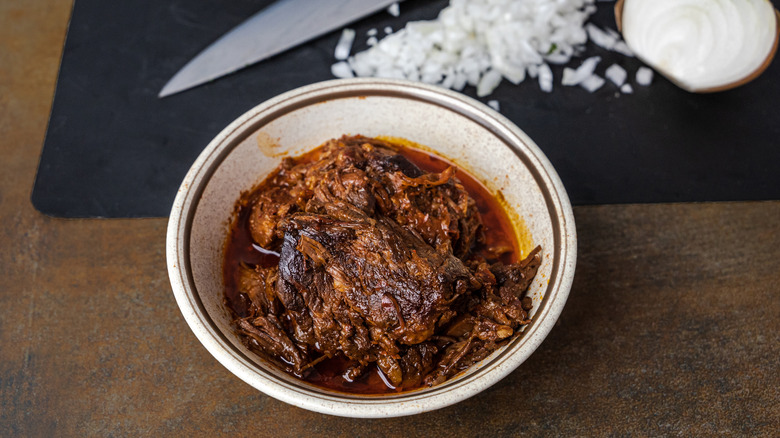 bowl of birria and chopped onions