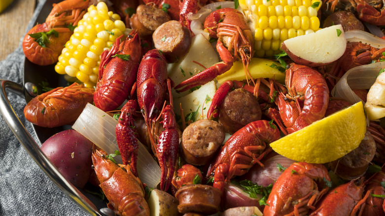 Close up of seafood boil with shrimp, sausage, potatoes, and corn