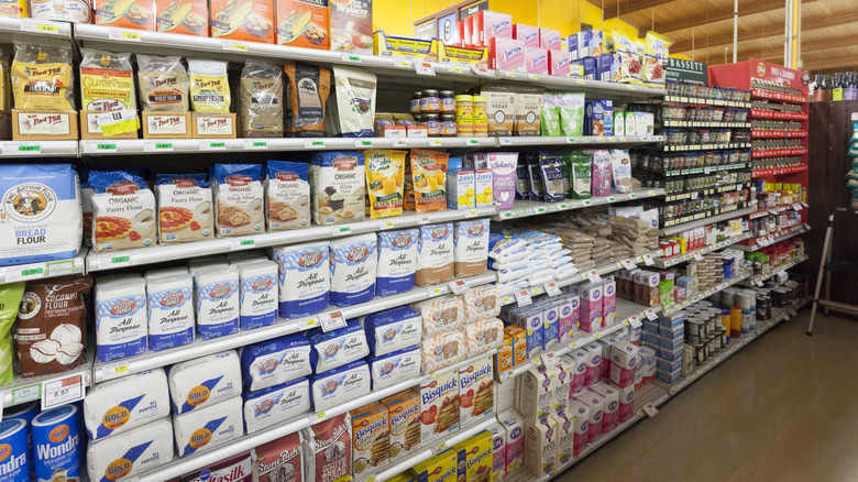 Cooking supplies section of a grocery store with the spice rack at the end