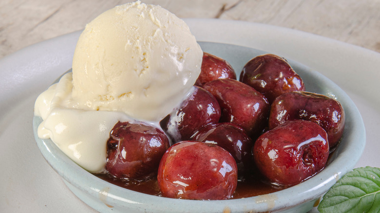 Bowl of cherries with vanilla ice cream