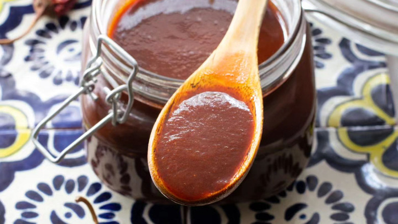 Jar and spoon of guajillo sauce