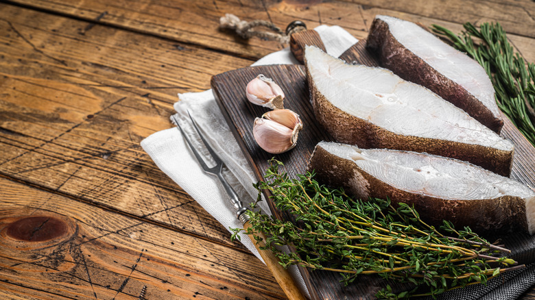 Raw Atlantic halibut steaks with thyme and garlic