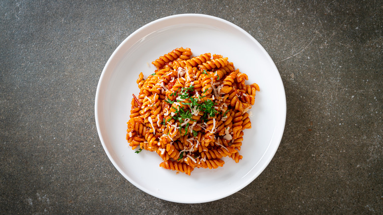 A plate of rotini with meat sauce