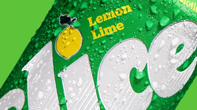 A closeup of a can of lemon-lime Slice soda, covered in condensation
