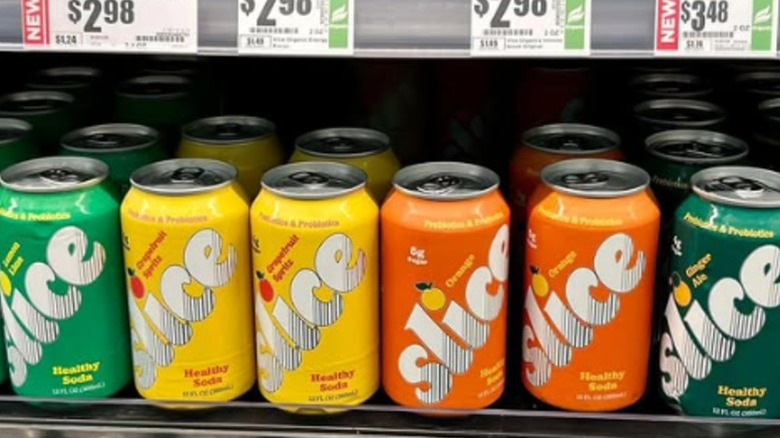 Cans of Slice on a shelf at a store