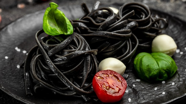 Black pasta on black plate 