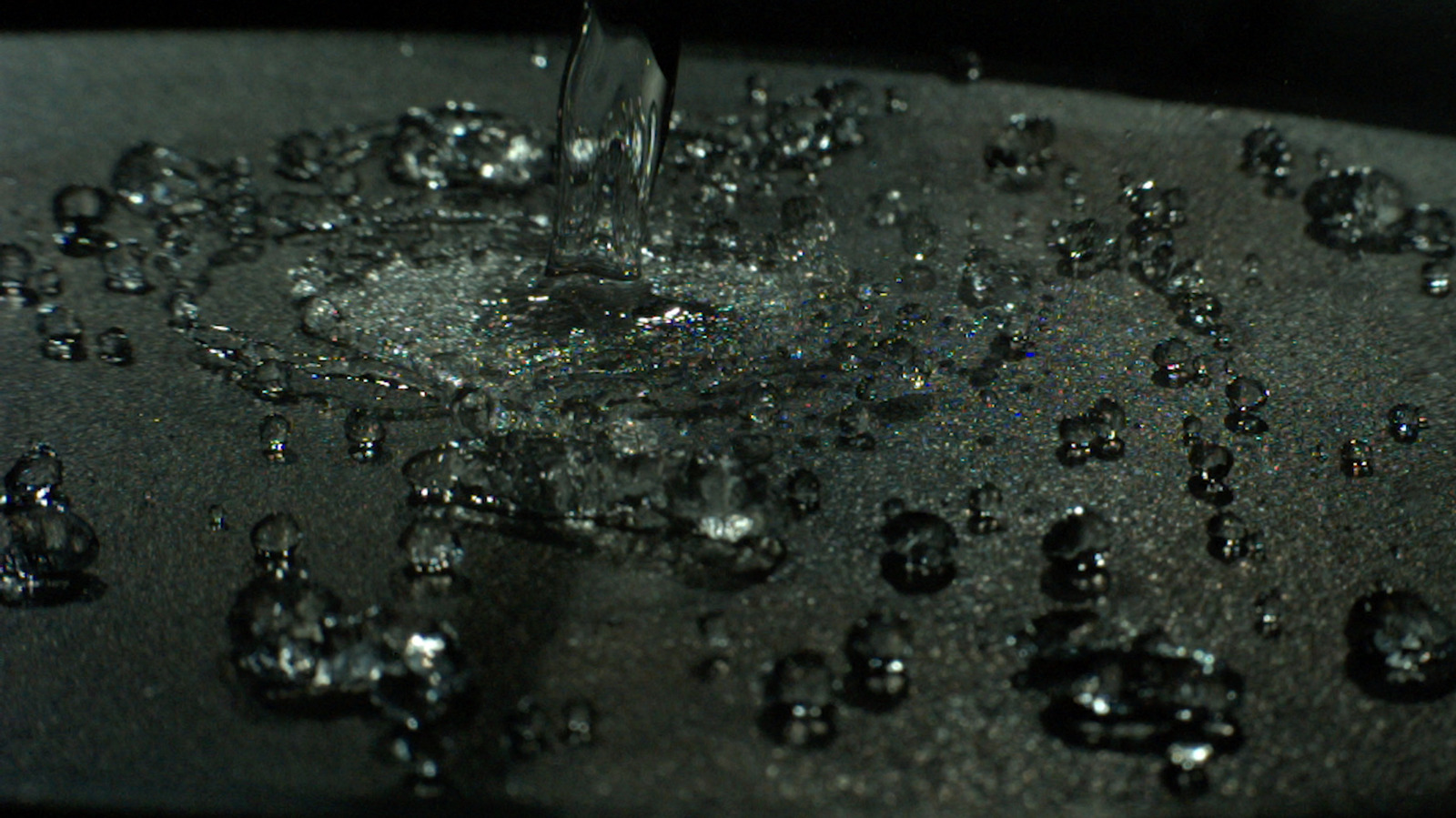 Leidenfrost point test on cast iron grill pan water droplets