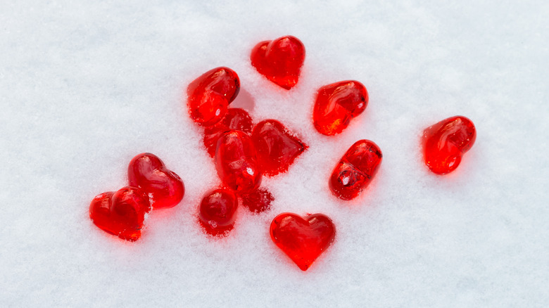 Snow with candy hearts on top of it.