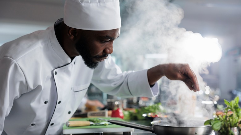 a chef seasons food to taste