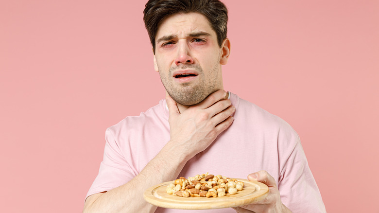 Man choking on mixed nuts