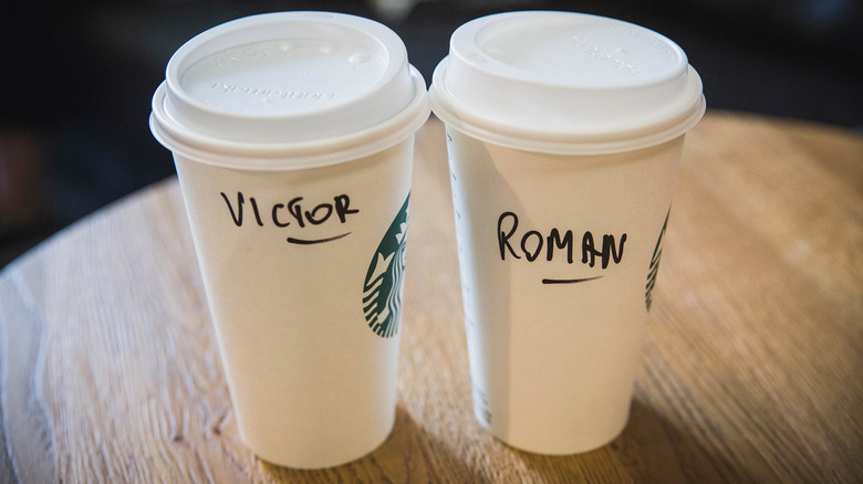 Starbucks cups with names wood table
