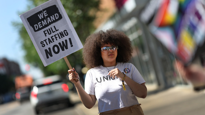 Starbucks protestor holding sign