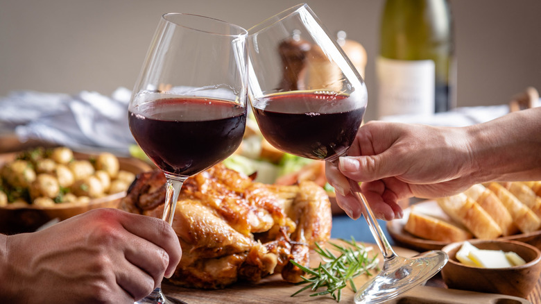 Two glasses of red wine in front of a Turkey dinner