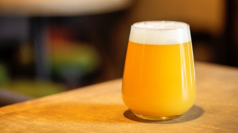 Hazy orange beer in taster glass