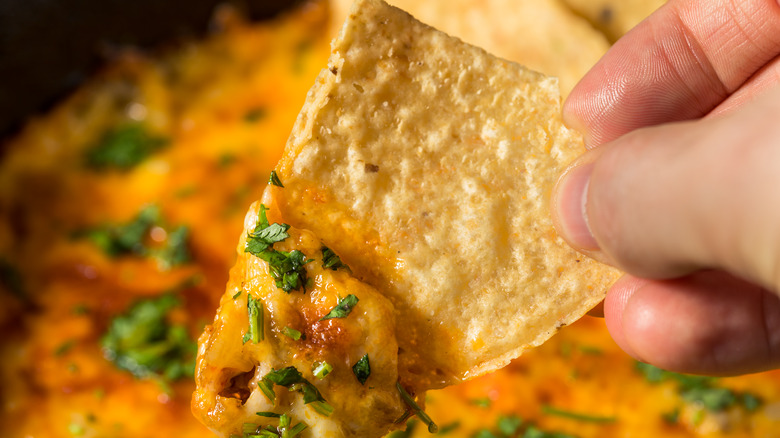 chip dipped in queso