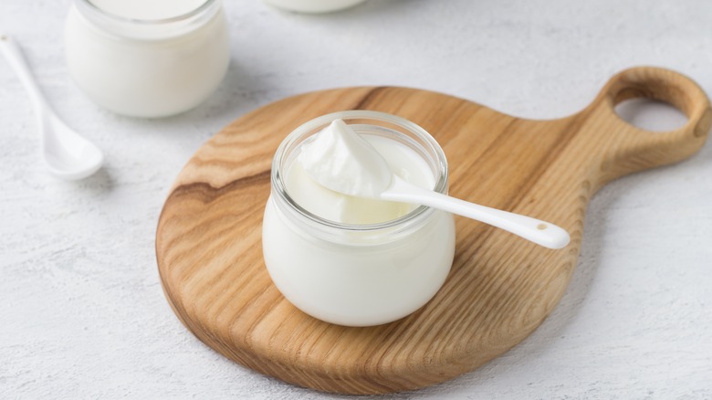 Yogurt in a jar on a wooden serving board
