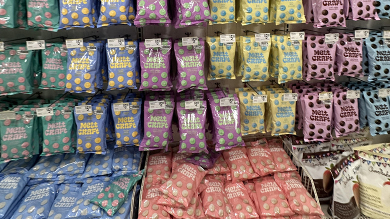 Colorful bags of candy melts hanging up in a Michaels store