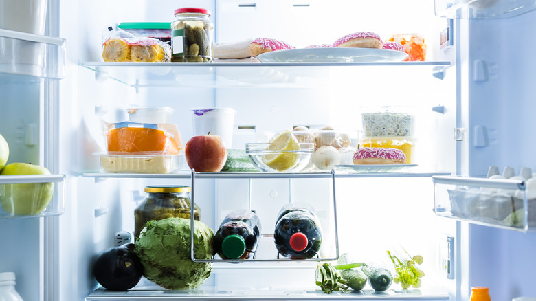 open refrigerator with various snacking foods