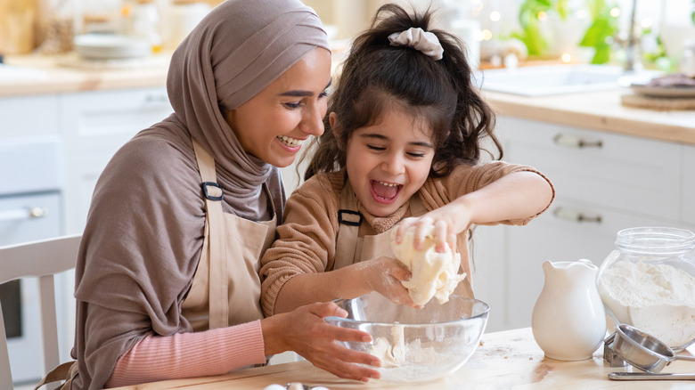 mom and daughter cooking together