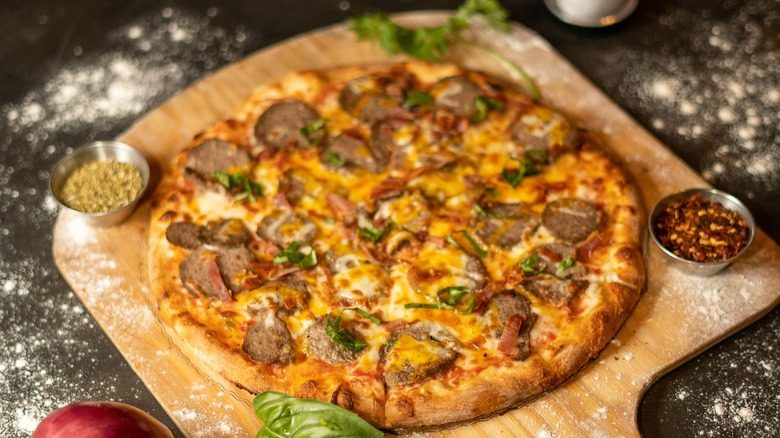 Sausage pizza on wood board