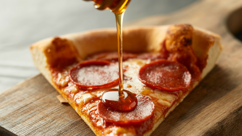 Slice of pepperoni pizza with hot honey drizzle