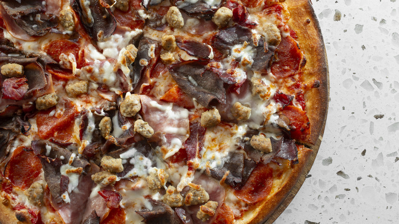 Partial section of a meat lovers pizza